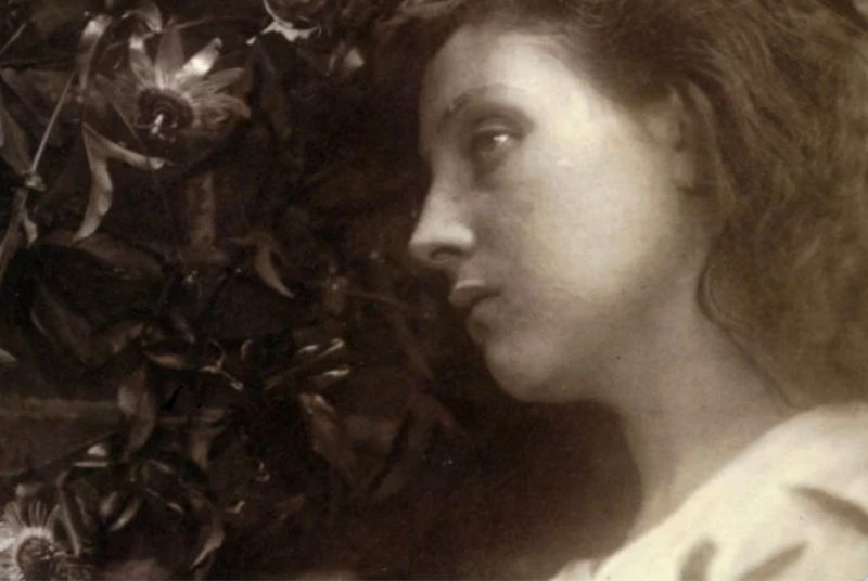 A woman with long hair in a diffused light.