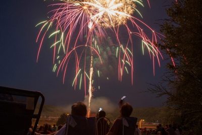 Red, gold, and green fireworks light up the night sky