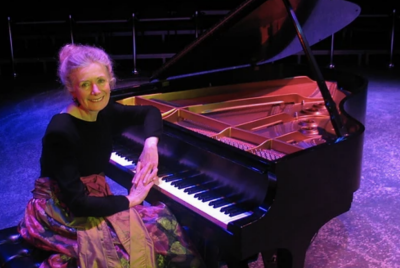 Barbara Nissman seated at a grand piano