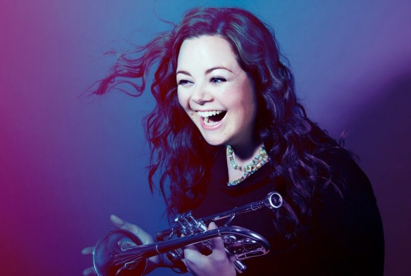 Nadje Noordhuis A woman holding a trumpet, laughing